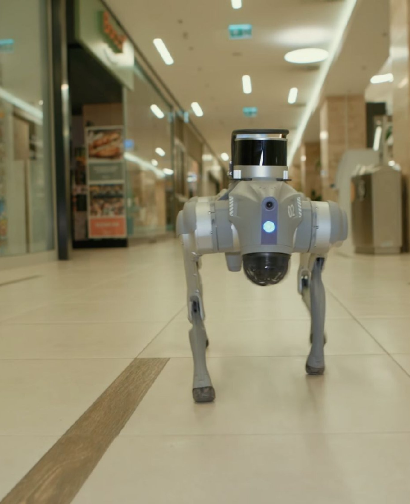 A Nortemsy patrol robot walking through a shopping centre corridor